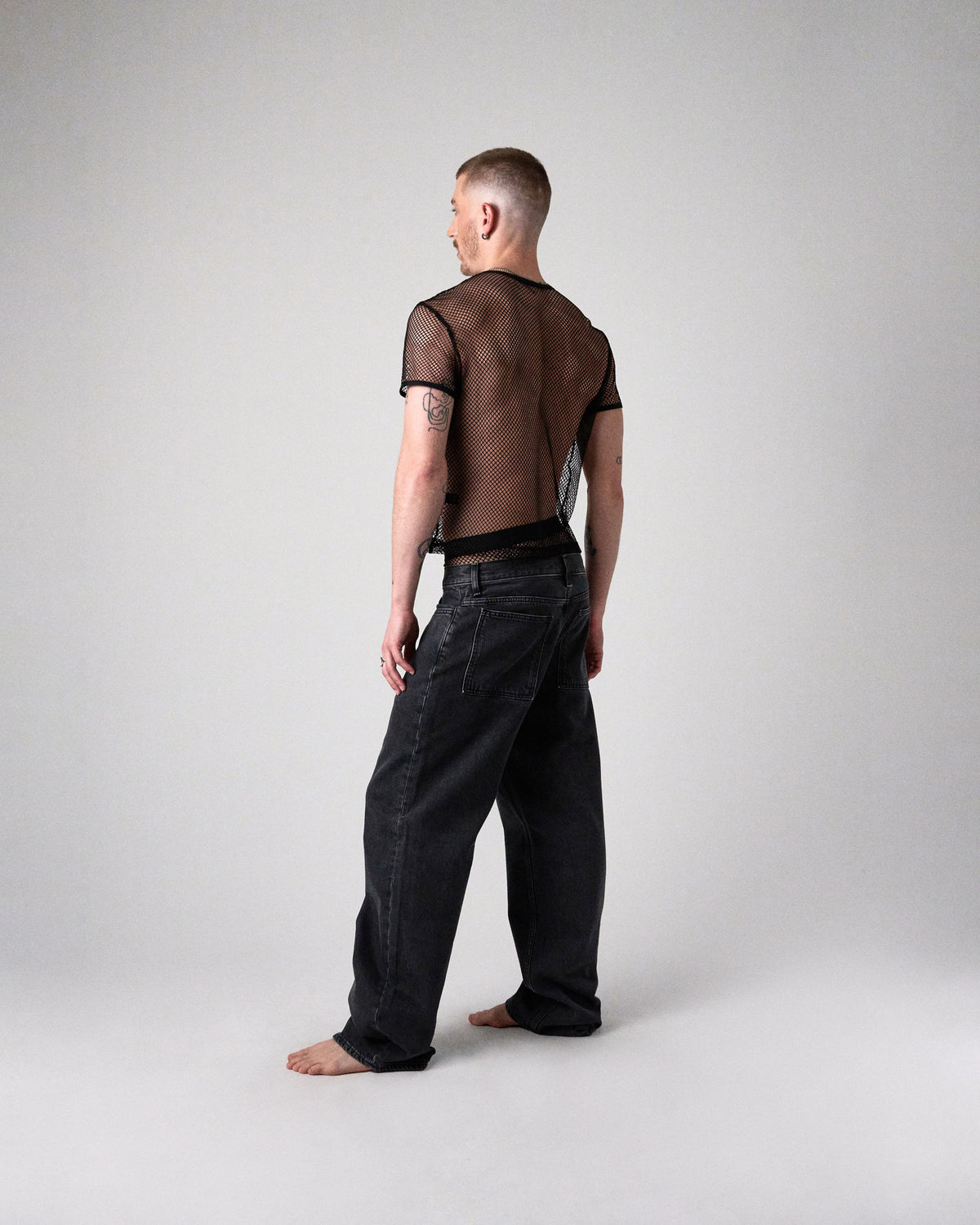 Edge Net Cropped Tee in Jet, full-length back view on model with black jeans