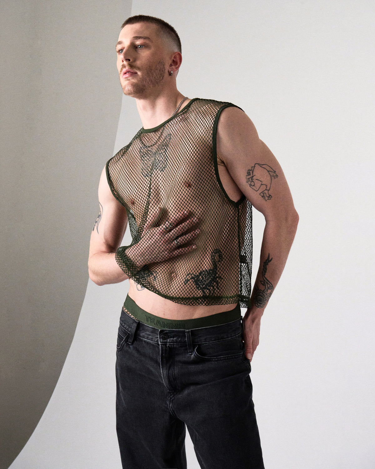 Edge Net Muscle Tank in Forest, three-quarter front view showing the cropped hem