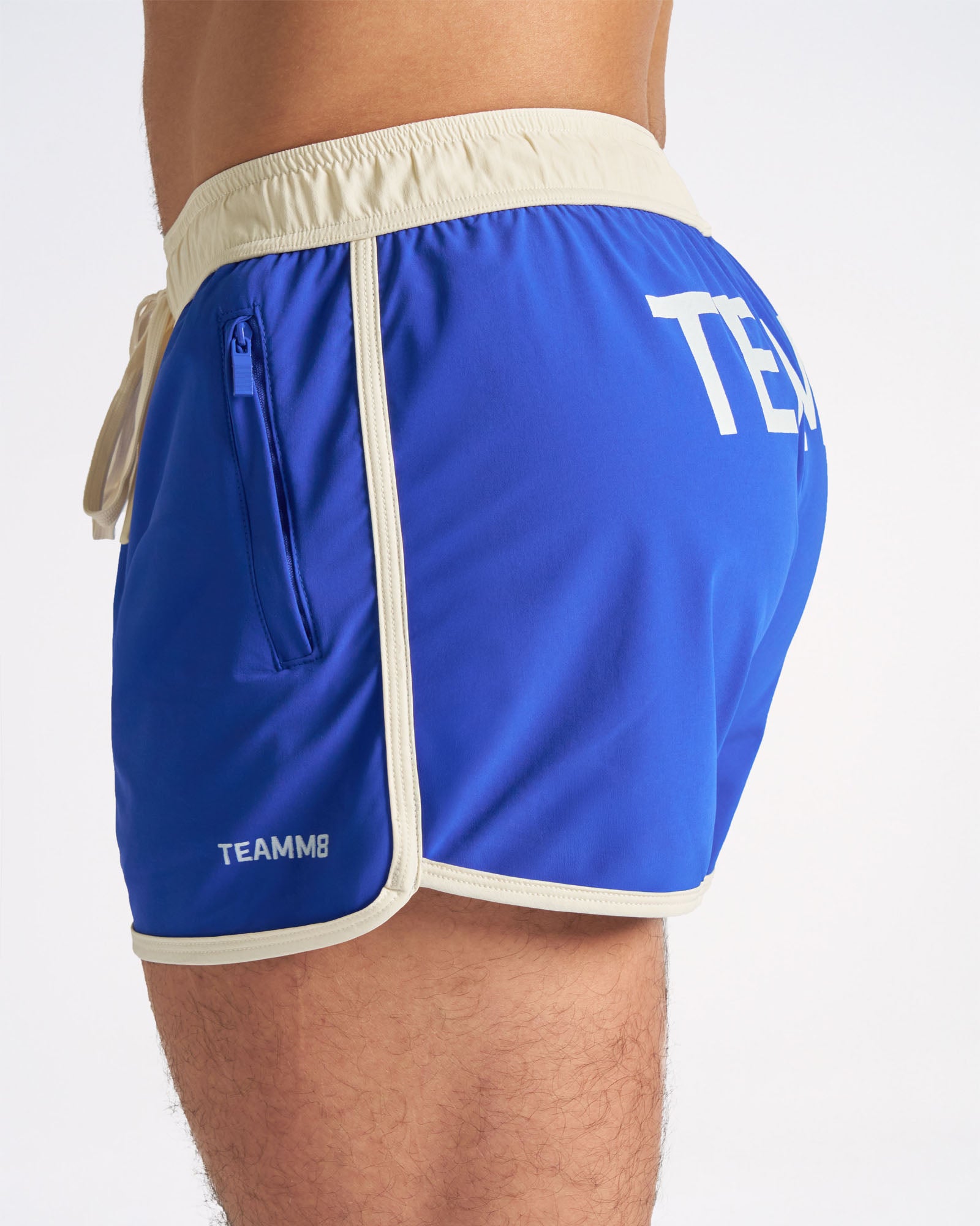 Blue shorts with 'TEAMMB' branding on a white background