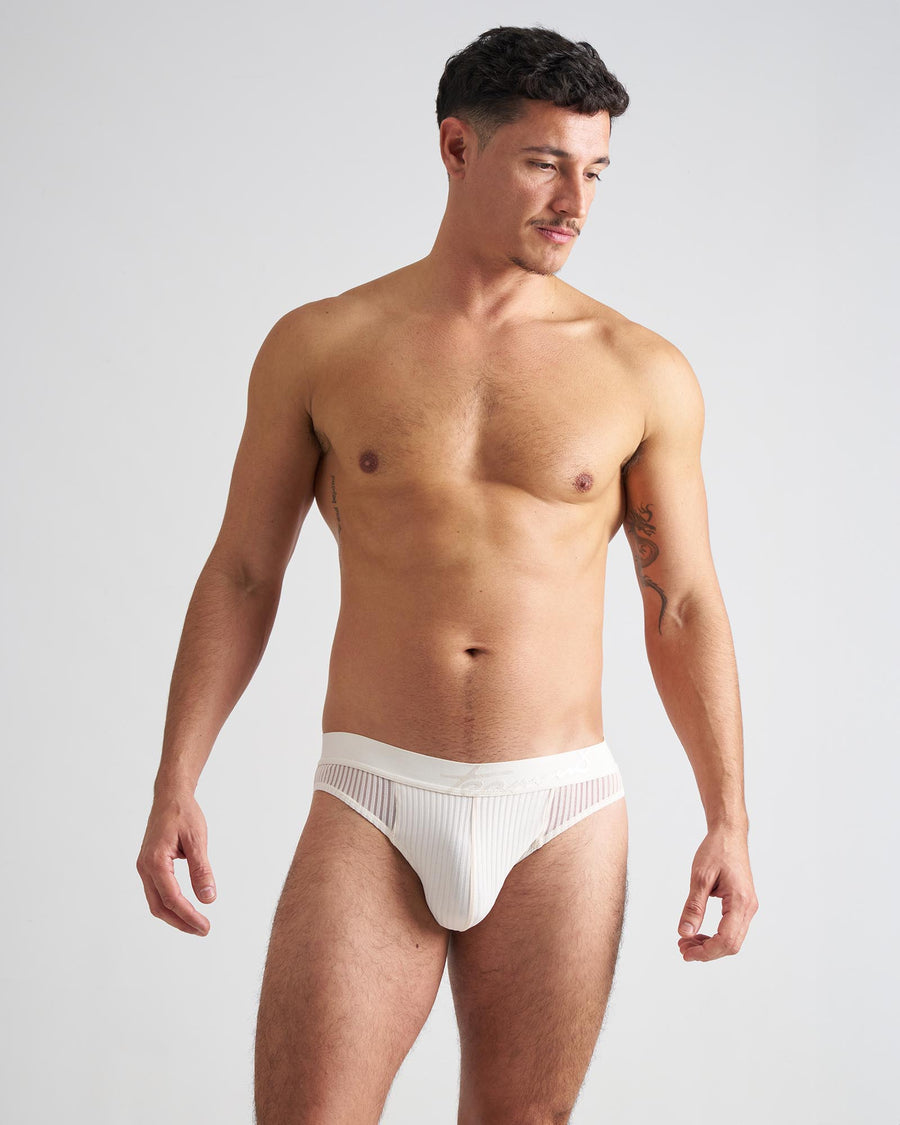Man wearing a white men's underwear on a plain background