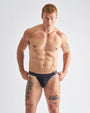 Man wearing black underwear against a white background